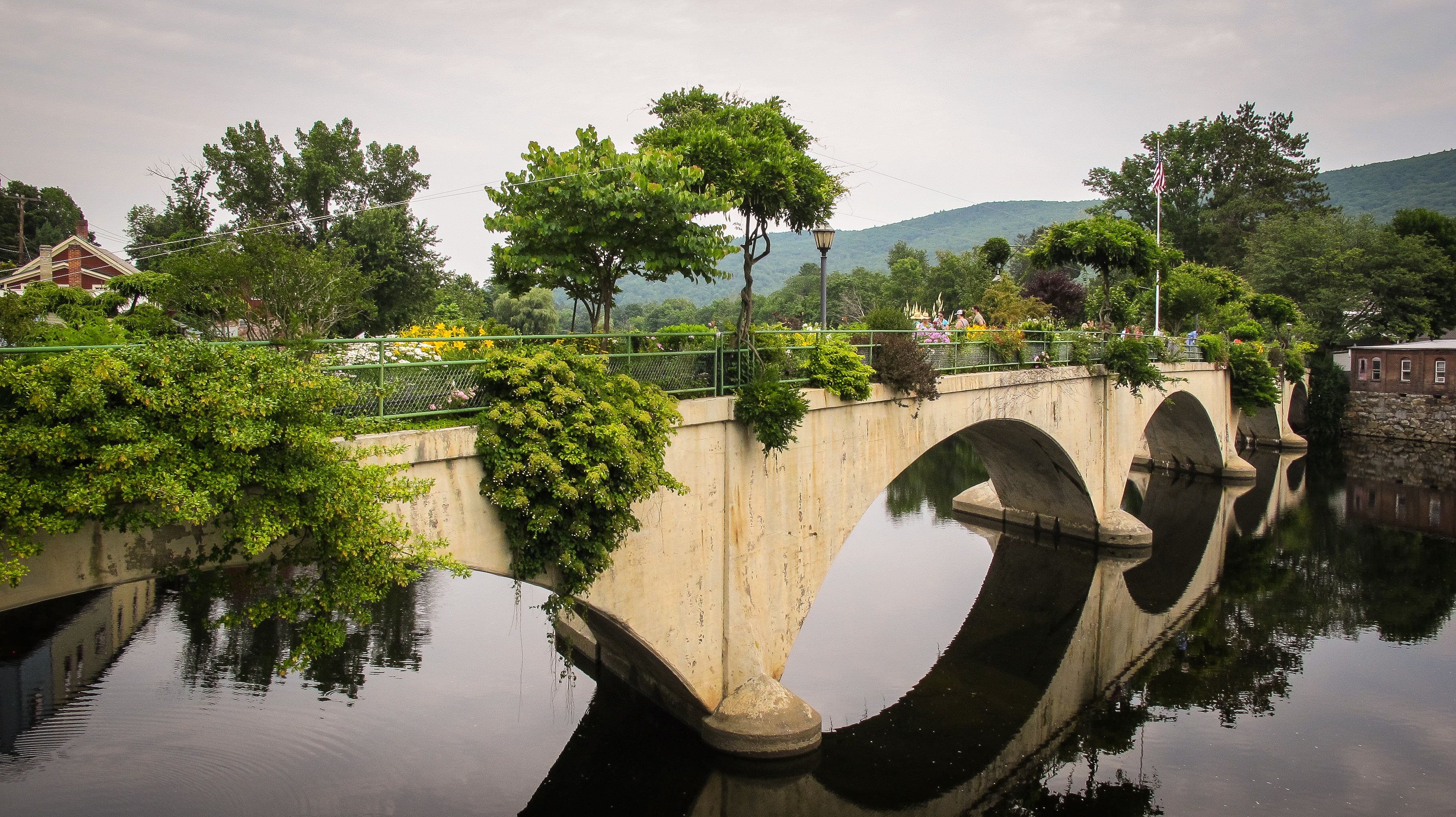 Bridge of Flowers in Shelburne Falls in full July bloom with flowers on both sides